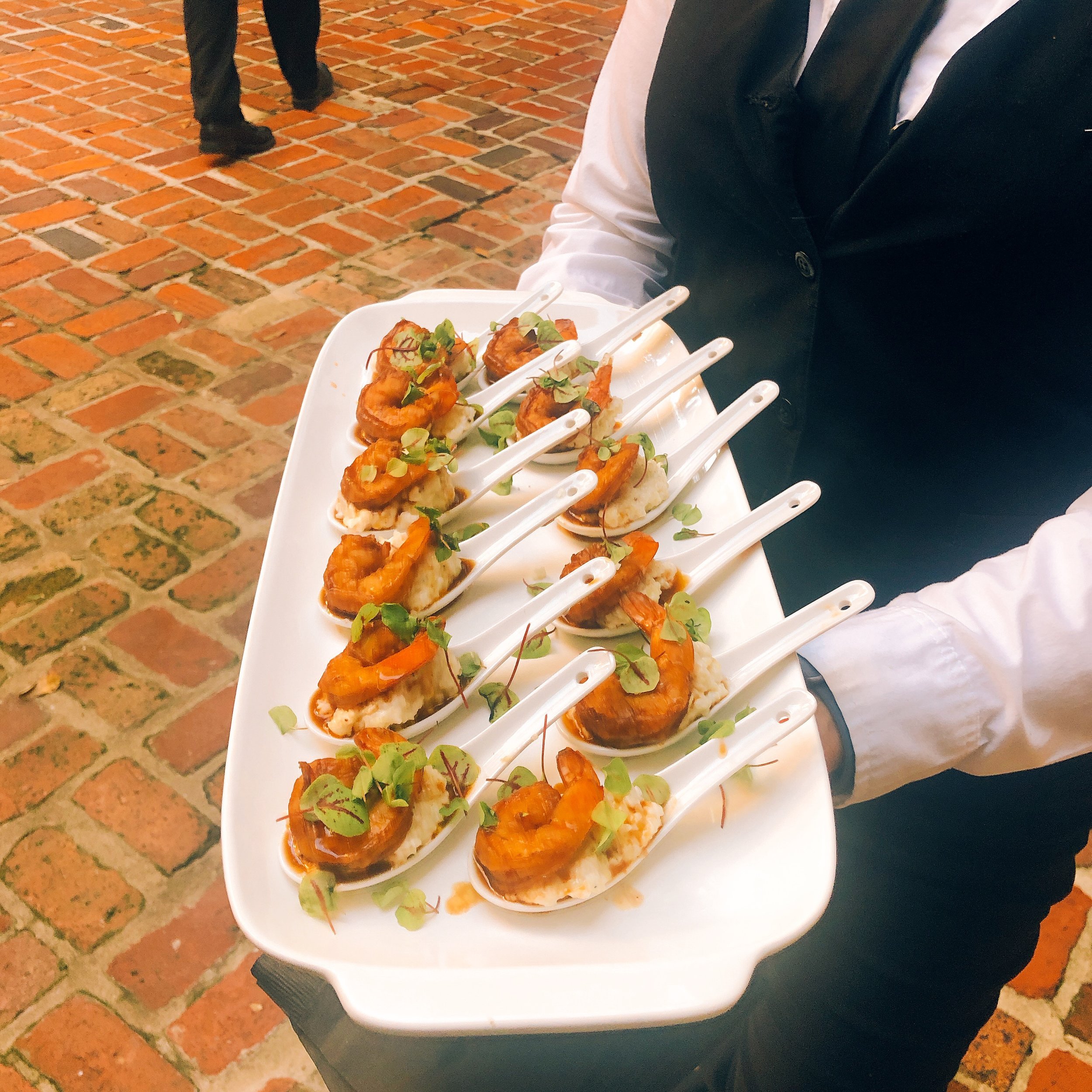 Mini BBQ shrimp and GritsLocal Gulf Gumbo Shrimp with Cajun BBQ sauce and creamy infused goat cheese and thyme grits.